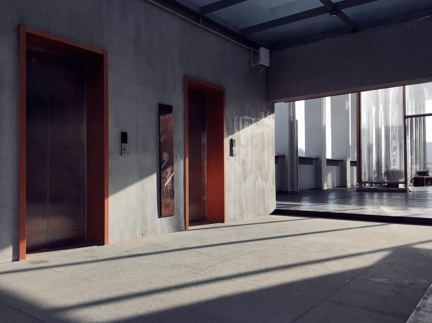 A minimal commercial interior with sunlight and strong shadows