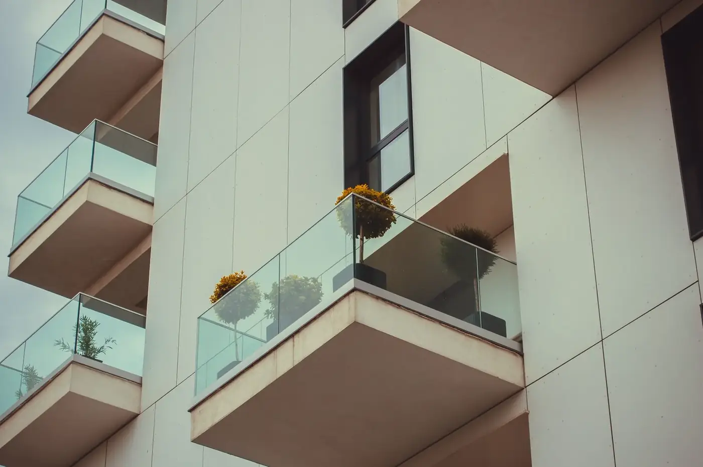 Glass balconies on a modern apartment building facade