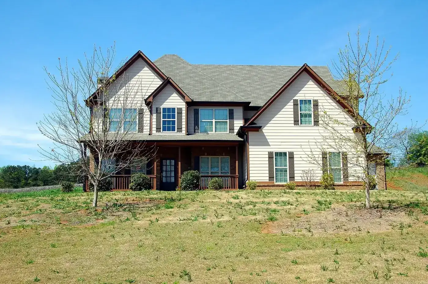 A two-storey suburban home with a wide front lawn